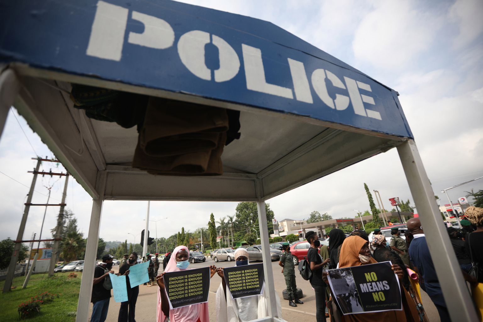 Protesters wearing face mask, hold placards and banners outside the Nigerian Police Headquarters in Abuja, Nigeria, during a demonstration to raise awareness about sexual violence in Nigeria on June 5, 2020. - Recent cases of abuse against minors by custodian has spread a wide-ranging protest and demands to create a public register of sexual offenders and also to declare a state of emergency on Gender Based Violence in Nigeria. (Photo by Kola Sulaimon / AFP)